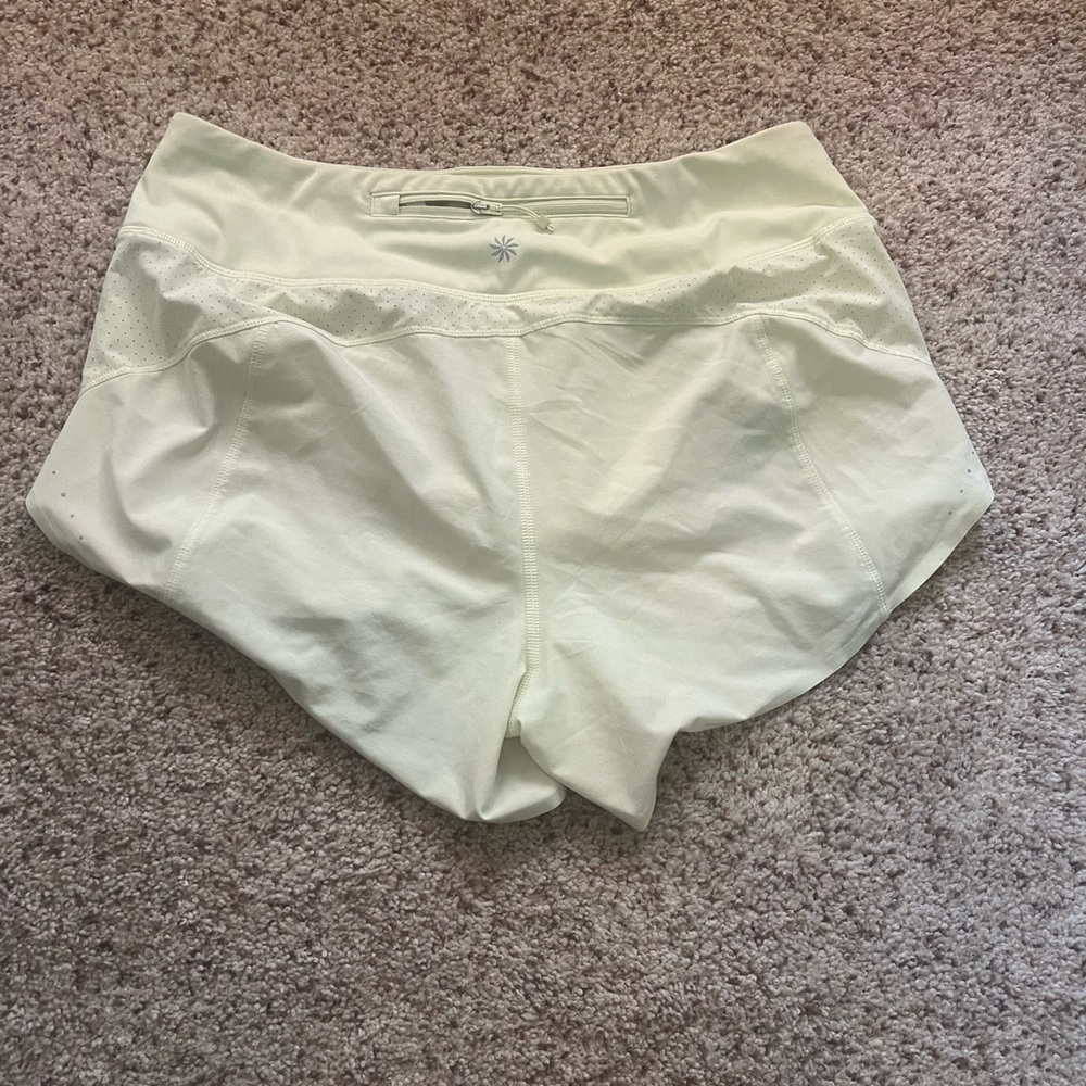 Athleta light yellow shorts with lining in small